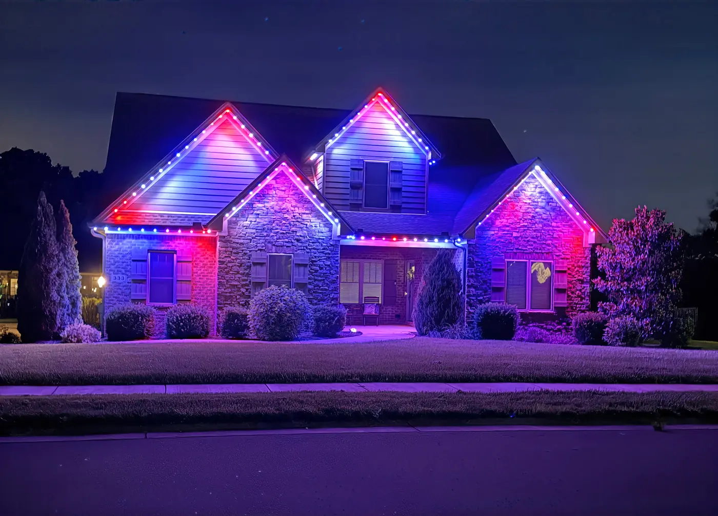 IronPeak install at night with red, green, blue, and purple pucks along the roofline